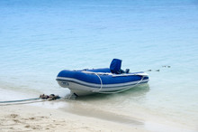 Inflatable Motor Boat On The Beach In Sunny Day
