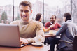 © zinkevych - Online game. Appealing cute nice man typing on laptop while enjoying coffee and emerging in virtual world