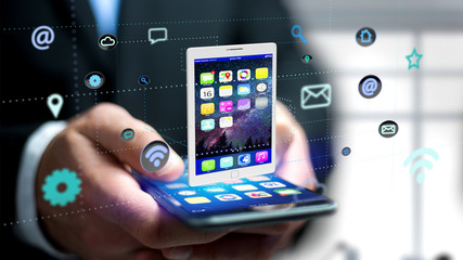 Poster - Businessman using a smartphone with a tablet surrounding by app and social icon - 3d render