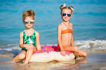 Happy girls on the sea. Cheerful girlfriends float on a circle on the sea