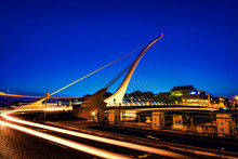 Samuel Becket Bridge At Sunset In Dublin, Ireland. Beautiful Architecture And Illuminated Hotels