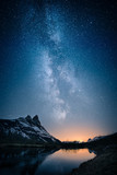 Fototapeta Fototapety góry  - Beautiful view of milky way glowing on the sky with mountains and river and reflections of stars