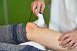 © dobok - Magnet therapy. Physical therapist treating patient knee