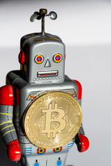 Wall Mural - vintage tin toy robot with bitcoin coin, cryptocurrency mining and investing concept