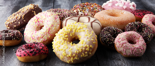 Fotomural assorted donuts with chocolate frosted, pink glazed and sprinkles donuts