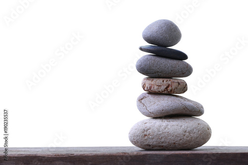Fotografía Balance Stones stacked placed on a wooden floor.