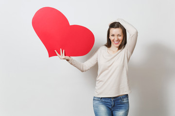 Pretty fun young smiling woman holding big red heart in hands isolated on white background. Copy space for advertisement. With place for text. St. Valentine's Day or International Women's Day concept.