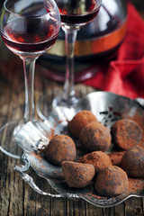 Dark chocolate truffles and two glasses of raspberry  liqueur