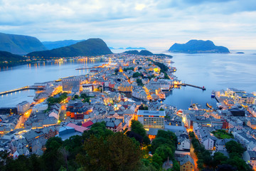 Wall Mural - Colorful sunset in Alesund port town on western coast of Norway. Place where the ocean meet the mountains