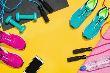 Wall Mural - Fitness accessories, healthy and active lifestyles concept background with copy space for text. Products with vibrant, punchy pastel colours and frame composition. Image taken from above, top view.