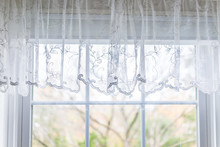 Closeup Of Small Short Lace White Window Curtains Blinds In Bright Room Interior Indoors With Pattern Design Decoration