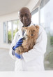 © JPC-PROD - portrait of a happy veterinarian and Yorkshire terrier in luxery pet hospital background