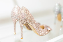 Beautiful Golden Glitter High Heel Female Shoes On   Glass Shelf. Wedding Accessories . Cinderella Shoes. Selective Focus