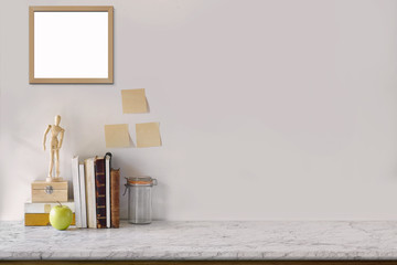 Wall Mural - Marble desk with books, blank white picture frame, puppet and sticky note. Mock up