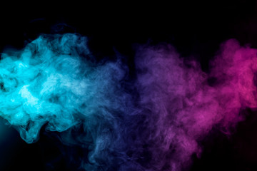 dense multicolored smoke of red, purple and pink colors on a black isolated background. background o