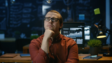 Poster - Young Office Worker Sitting in His Office and Thinking.