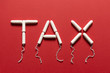 Tampons Forming the Word TAX on a Red Background