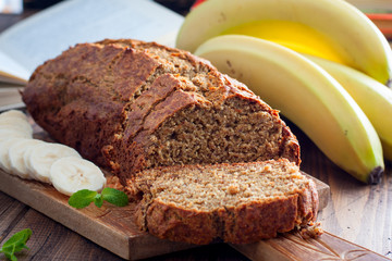 Sliced banana cake with whole-grain flour on a wooden board, selective focus