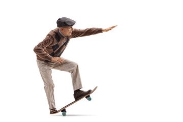 Senior riding a skateboard and doing a manual