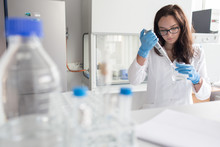 Woman Holding Flask In Lab