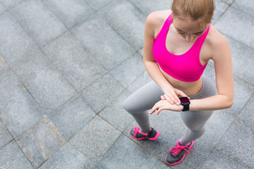 Wall Mural - Young female jogger with smartwatch