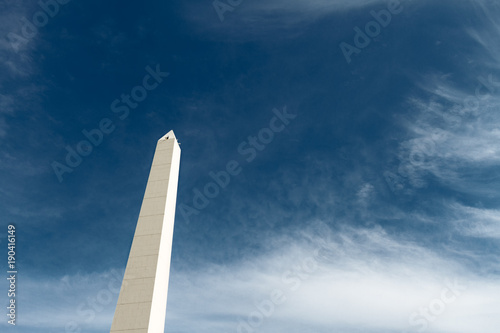Cuadros en Lienzo Obelisk of Buenos Aires (Argentina) seen from below against blue sky and clouds