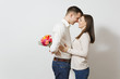 © ViDi Studio - Couple in love. Woman looking behind man who hiding behind him bouquet of beautiful roses flowers isolated on white background. St. Valentine's Day, International Women's Day birthday holiday concept