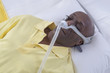 © JPC-PROD - Healthcare concept,African, American Man with obstructive sleep apnea sleeping well with cpap machine ,Man laying in bed wearing cpap mask, on white backgroud