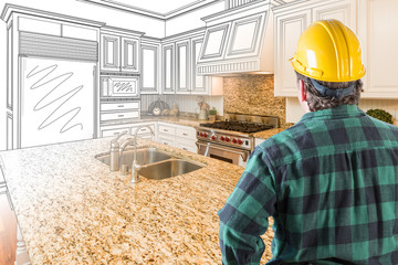 Wall Mural - Male Contractor with Hard Hat and Tool Belt Looking At Custom Kitchen Drawing Photo Combination On White.