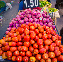 Tomatoes And Red Onions At A Market
