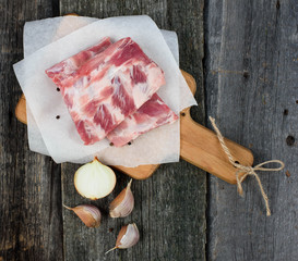 fresh pork ribs on a cutting Board, wooden background