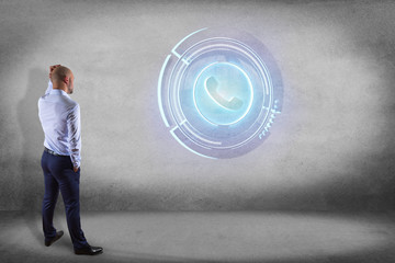 Poster - Businessman in front of a wall with a Shinny technologic phone button - 3d render