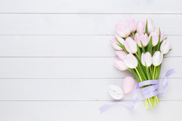 Pink tulip on the white background. Easter background.