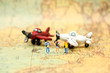 Miniature people : travelers with backpack standing on world map and mini airplane,backpack and travel concept.
