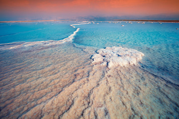 Sunrise over Dead Sea. Salty textured sea shore. Wilderness of Israel 