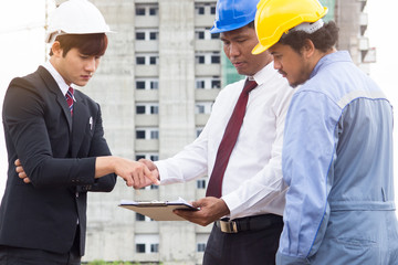 Building consultant. engineer and contractor discussing material specification from client in construction site area.