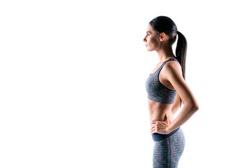 Poster - Side profile half-faced portrait of focused sexy slim young sportswoman wearing fashionable comfortable sportive outfit, she is staying still, isolated on white background, copyspace