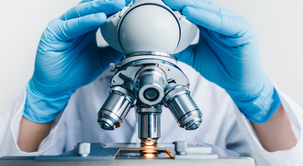 Wall Mural - close-up shot of microscope with metal lens at laboratory.