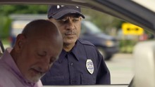 Police Officer Talking To Man During Traffic Stop