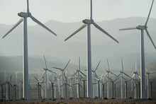 View Of Windmills On Field Against Mountains