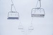 Skilift in ski resort in white winter mist
