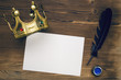 Blank paper sheet with pen and golden crown on wooden table background. Vip agreement. Premium contract. Special offer.
