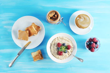 Wall Mural - Breakfast oatmeal on a blue background