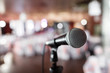 © malkovkosta - Microphone close-up. Focus on mic. Abstract blurred conference hall or wedding banquet on background. Event concept