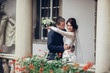 © VAKSMANV - Newlyweds kissing and smiling on their wedding day on the walk o