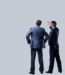 Two businessman looking at white background.