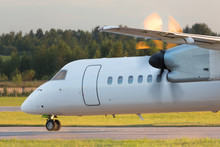 Airplane With Turboprop Engine With Propeller In Motion Taxing On Runway, Close Up, Horizontal, Part Of Aircraft Fuselage, Side View/ Aircraft Propeller In Motion/ Turboprop Plane Rides On Runway