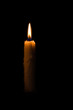 © Odua Images - One light candle burning brightly in the black background