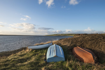 Wall Mural - Beautiful vibrant sunset landscape image of boats moored in Fleet Lagoon in Dorset England
