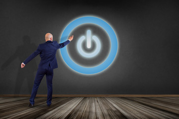 Poster - Businessman in front of a wall with Power button symbol displayed on a futuristic interface - Technology and energy concept